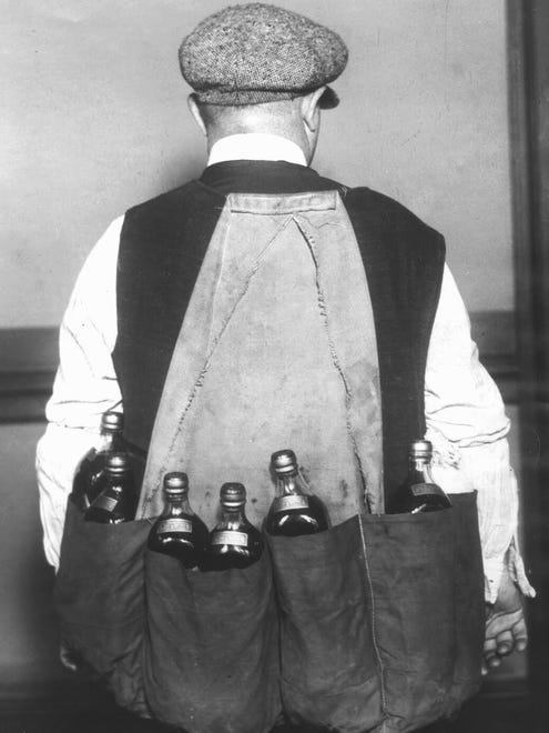 A smuggler wears a simple device to help him smuggle multiple bottles of liquor under his coat during prohibition.