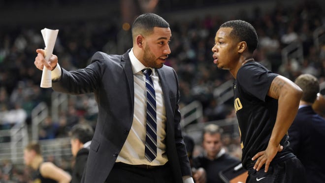 Drew Valentine (left) coaches Nick Daniels as an assistant on Oakland University's staff.