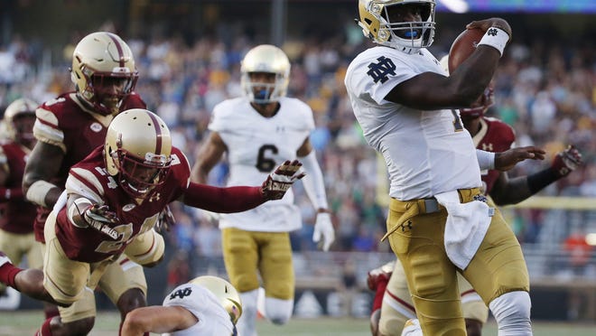 Notre Dame quarterback Brandon Wimbush, right, rushed for 207 yards and four scores in last week’s win over Boston College.