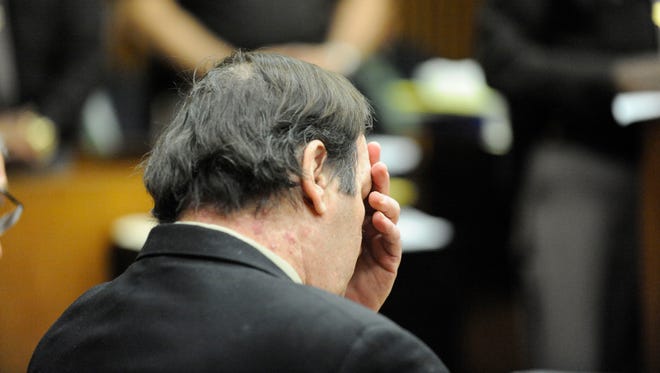 Bob Bashara covers his face with his hand as the five guilty verdicts are read by the jury foreman.