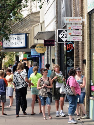 Visitors to downtown Traverse City walk down Front Street.