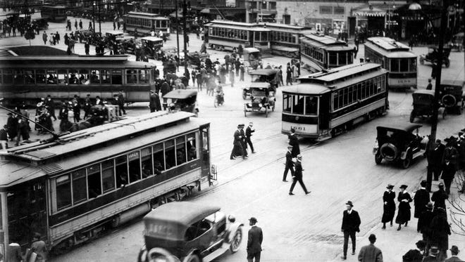 Pedestrians crossed the street wherever they pleased at Campus Martius in 1917. Soon, laws about jaywalking would be put in place.
