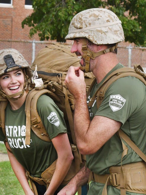 Supermodel and actress Kate Upton and her fiancee Justin Verlander try on Marine rucksacks and helmets after a 'Marine Week' workout for Kate at the Wayne State University football field in Detroit, Michigan on August 22, 2017.