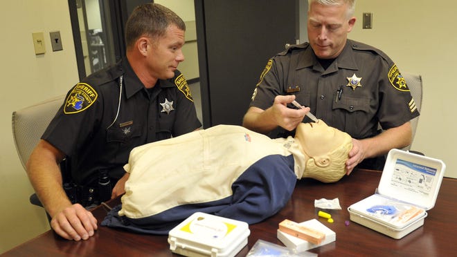 August 4th 2015: The Oakland County Sheriffs Department in Waterford has a kit that will off-set a drug overdose. Its called the Narcan. left to right are Oakland County Sheriff Deputy, Adam Kammer and Sgt. Todd Hill demo the kit on a training dummy. Photo by Charles V. Tines, The Detroit News.