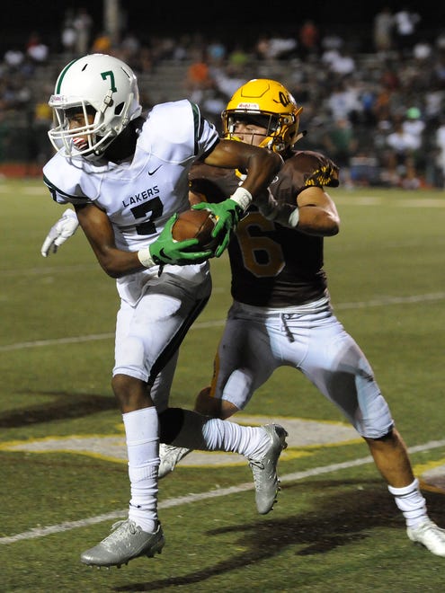 West Bloomfield receiver Tre Mosley (7) makes a catch against Rochester Adams defender Chase Kareta (6) and runs for a touchdown in the second half during a high school football game Friday, September 22, 2017 Adams High School. It was a 98 yard touchdown and with the extra point put West Bloomfield up 17-10.