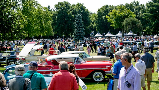 People walk around at the 40th annual Concours d'Elegance of America car show.
