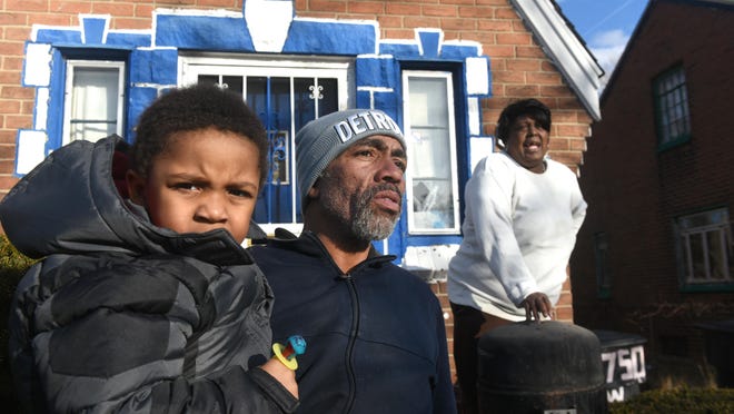 Richard Johnson Jr. holds his son Richard Johnson III outside the home of Latasha Tucker who faced eviction from a house filled with significant health hazards in this file photo from February 16, 2017. Johnson tried to help Tucker stem frequent sewage backups in her basement. Her landlord snaked the drain, but the problem persisted and she ceased paying rent, which led to an eviction bid that was eventually dropped when she agreed to move out.