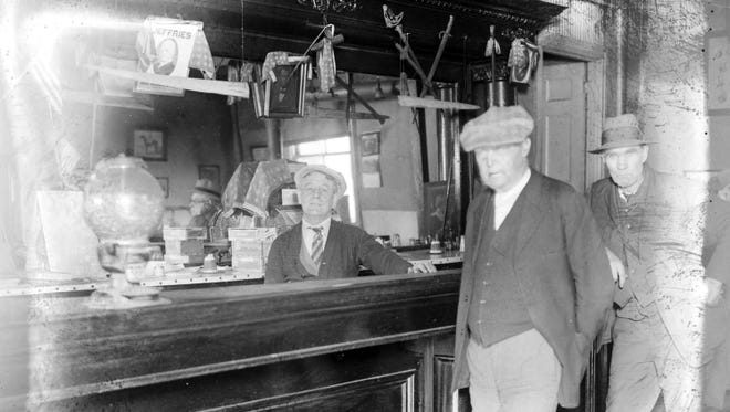 The Bucket of Blood was owned by Billy Boushaw, left, seen in 1929. A 1908 editorial said, "For the most part it is a tough set that frequent the place - scum." A portrait of Abraham Lincoln is seen behind Boushaw. The picture of  "Jeffries" above the bar is likely Recorder's Court Judge Edward J. Jeffries.