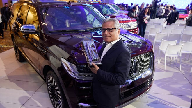 Kumar Galhotra, president of Lincoln Motor Co., poses with the award for truck of the year, won by the Lincoln Navigator.