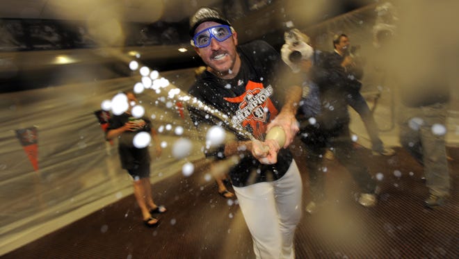 Detroit Tigers starting pitcher Justin Verlander celebrates in the locker room after the Tigers advanced to the World Series by defeating the New York Yankees in game four of the American League Championship Series at Comerica Park in Detroit, October 18, 2012.