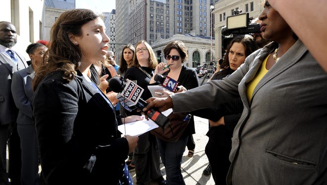 Renee Schenkman of Detroit, a former teacher at Experiencia Preparatory Academy, talks to the media in Detroit on Tuesday about a lawsuit challenging literacy efforts in schools.