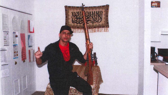 Photos found on Yousef Ramadan's electronic devices show the Ypsilanti man posing with pistols and rifles.