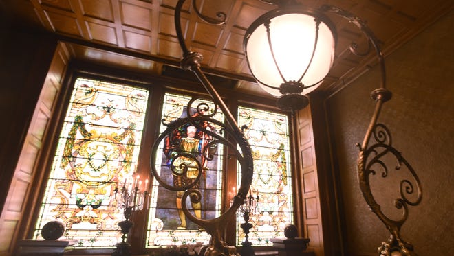 Beautiful details adorn the stairway past the second floor stain glass windows.