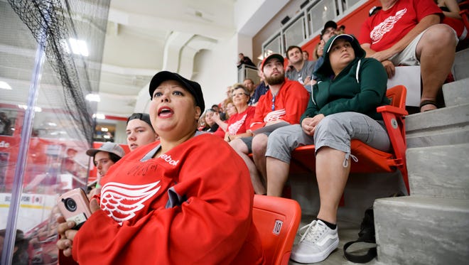 Jennifer Reed, of Grand Rapids, watches a recent Red Wings scrimmage from the stands at the practice arena at Little Caesars Arena.
