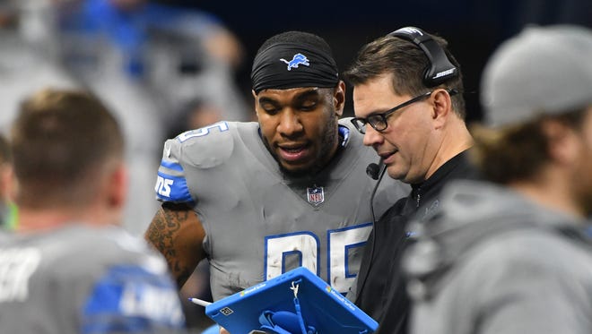 Lions tight end Eric Ebron and tight ends coach Al Golden go over Ebron's touchdown reception on the sidelines in the third quarter.