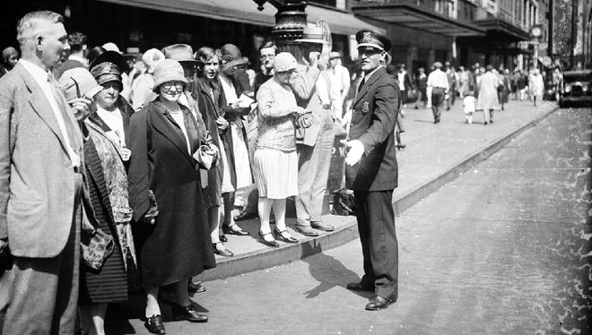 A policeman directs foot traffic during an anti-jaywalking campaign in 1929.
