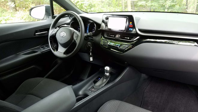The interior of the Toyota C-HR, like its exterior, sports a split, horizontal element with a raided infotainment screen for better driver viewing.