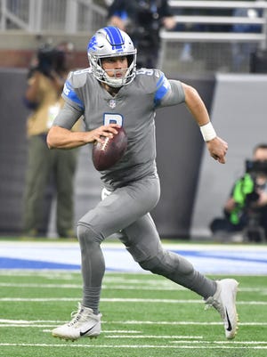 Lions quarterback Matthew Stafford scrambles out of pressure and throws a long reception to Marvin Jones Jr. in the second quarter against the Bears.