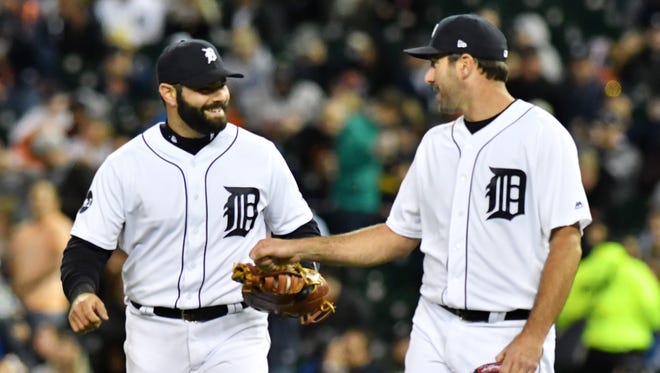 Tigers pitcher Justin Verlander, right, congratulates Alex Avila after Avila makes a catch in foul territory to end the top of the seventh inning in the game with the Texas Rangers at Comerica Park in Detroit on May 20, 2017.