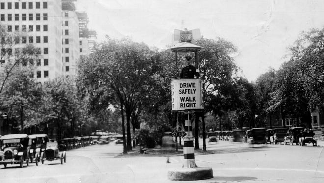 The first U.S. stop sign was used in Detroit in 1915, and the first traffic lights, at the time called street semaphores, were invented and developed in Detroit. Above, a Traffic Squad officer mans a crow's nest on Grand Boulevard in 1926.