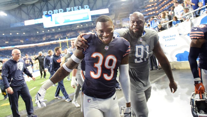 Bears' rookie defensive back Eddie Jackson walks out with Lions' defensive tackle A'Shawn Robinson, a fellow Alabama University football player, after Detroit beat Chicago 20-10.