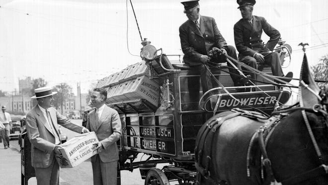 Decades before they became TV advertising icons, the Budweiser Clydesdales did real deliveries, like this one to a Detroit customer in 1933.