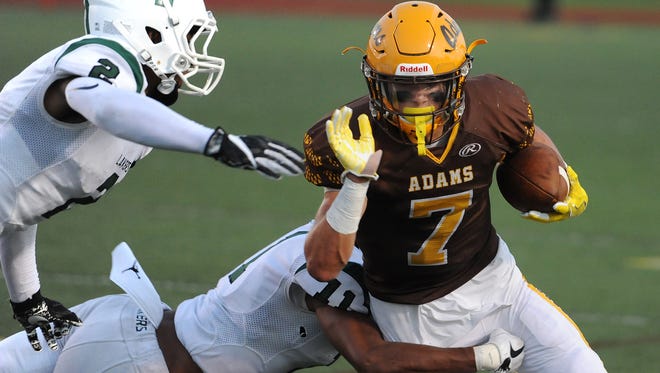 Rochester Adams running back Cole Patritto (7) breaks to the outside against West Bloomfield in the first half.