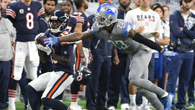 Bears' Kendall Wright pulls in a reception with Lions' Darius Slay defending along the sidelines in the fourth quarter.