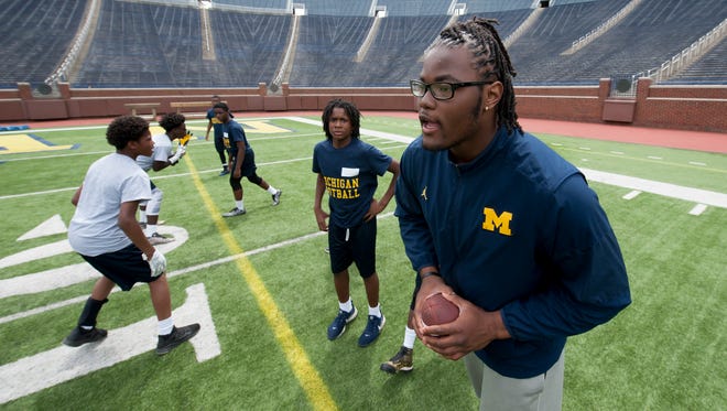 Michigan defensive end Rashan Gary runs a scrimmage with some of the students during the Youth Impact Program this week at Michigan Stadium.
