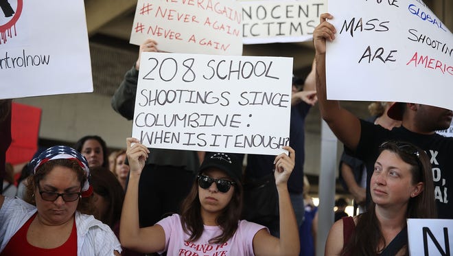 People join together after a school shooting that killed 17 to protest against guns on the steps of the Broward County Federal courthouse on February 17, 2018 in Fort Lauderdale, Florida.