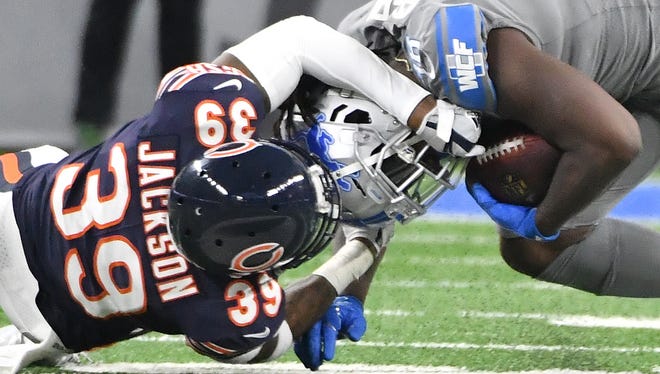 Bears' Eddie Jackson drags down Lions' Tion Green in the fourth quarter.