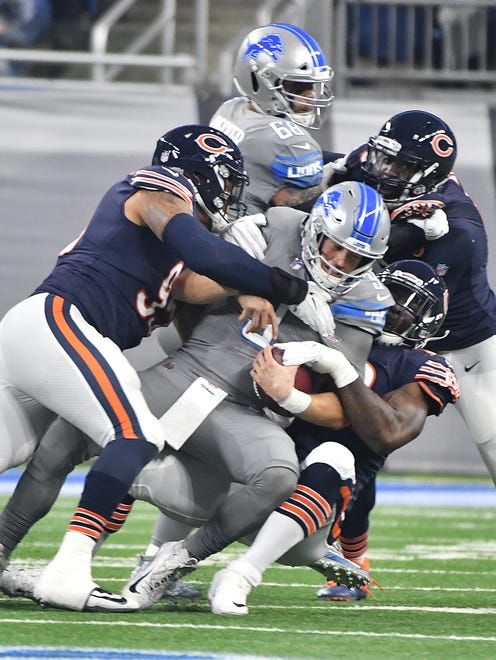 Lions quarterback Matthew Stafford is sacked by Bears' Roy Robertson-Harris and Lamarr Houston in the first quarter.