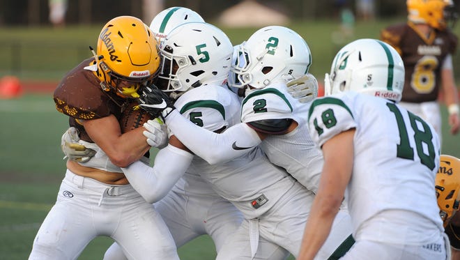 Rochester Adams running back Chase Kareta is stacked up by the West Bloomfield defense in the first half Friday. West Bloomfield won, 17-16.