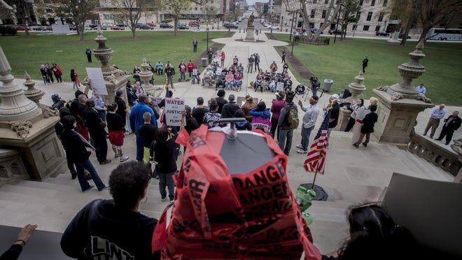 More than 50 Flint residents rally on the five-year anniversary of the Flint water crisis at the Capitol Building on Thursday, April 25, 2019, in Lansing, Mich.