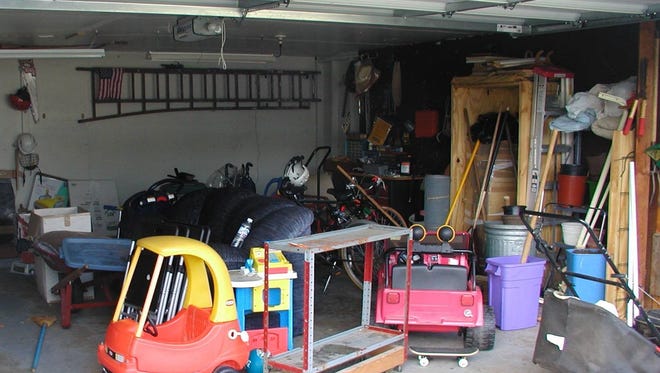 A "before" shot of a cluttered garage. Lindley's mantra is "a place for everything and everything in its place." "So often, clutter accumulates when there isn't a place for it," she said.