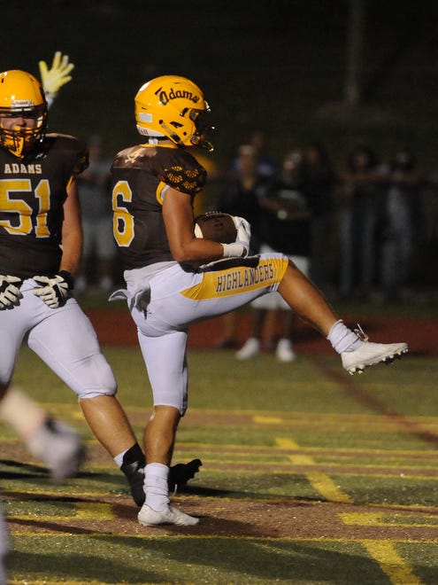 Rochester Adams running back Chase Kareta (6) high steps into the end zone scoring a touchdown against West Bloomfield  in the second half during a high school football game.