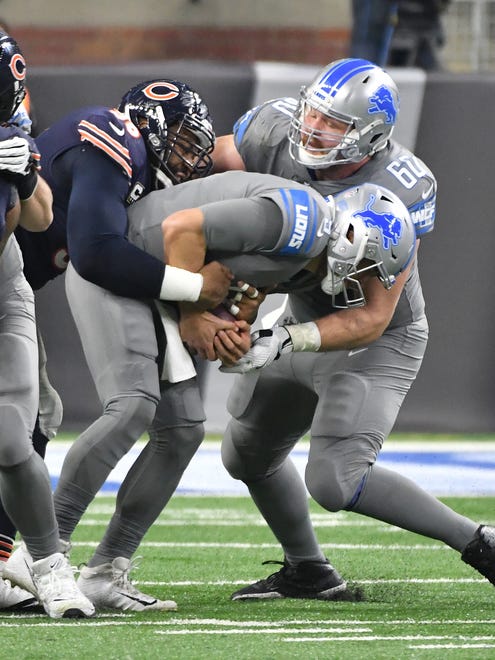 Lions quarterback Matthew Stafford is sacked by Bears' Akiem Hicks, with Detroit teammate Graham Glasgow trying to take some of the hit off Stafford, in the third quarter.