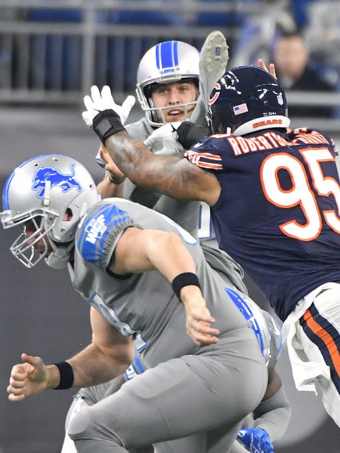 Lions punter Sam Martin gets jostled by Bears' Roy Robertson-Harris but no call is made in the first quarter.