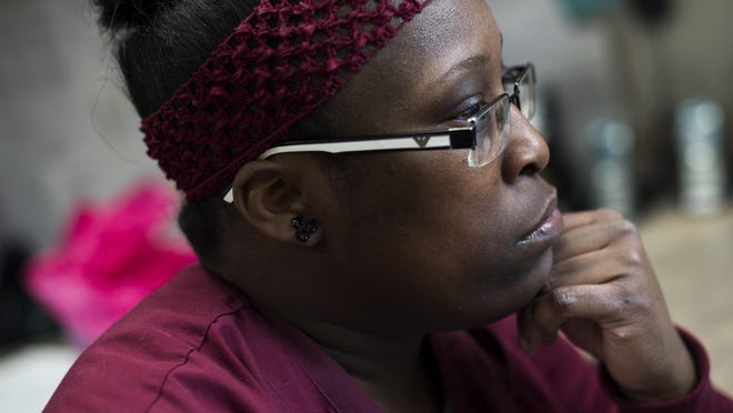 Nedra Smith, a patient care technician and graduate of the Detroit At Work healthcare training program, works on charts and records at St. John Hospital in Detroit. Detroit At Work connects Detroit residents to a free training program in certain career paths.