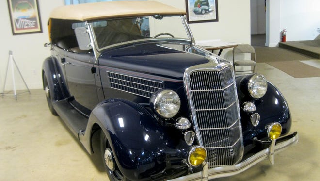 This four-door 1935 Ford cabriolet became a street rod when owner Larry Smith had it lowered, dropped the front axle and added dual exhausts for its original engine.