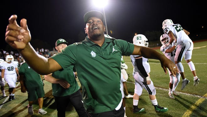 West Bloomfield head coach Ron Bellamy celebrates with his team after defeating Rochester Adams 17-16 in a high school football game Friday, September 22, 2017 Adams High School.