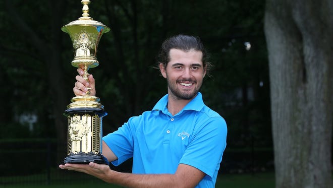 Curtis Luck from Australia celebrates with the Havemeyer Trophy after defeating Brad Dalke from Norman, Oklahoma 6-4 to win the U.S Amateur Championship Saturday played on the South Course of Oakland Hills Country Club.