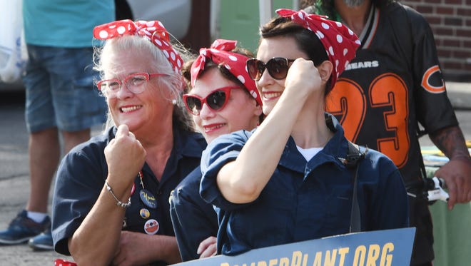 A group of "Rosie the Riveters" pose for pictures during the nostalgic car race going through Depot Town in Ypsilanti.