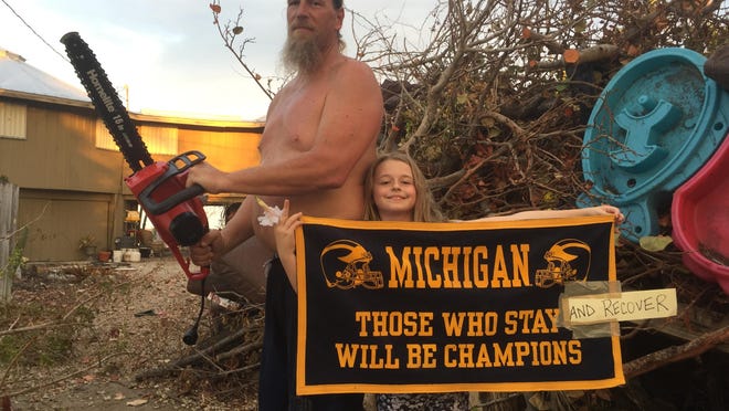 Former University of Michigan and NFL lineman Steve Everitt is tapping his Wolverine connections to raise money for hurricane relief as he clears debris near his home in the Florida Keys, with an assist from 8-year-old daughter Jamie. Photo by Amy Everitt ________________________________________