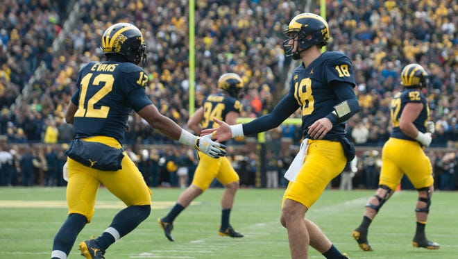 Michigan quarterback Brandon Peters, right, congratulates running back Chris Evans after he caught a 20-yard touchdown pass late in the second quarter in last week's win over Rutgers.