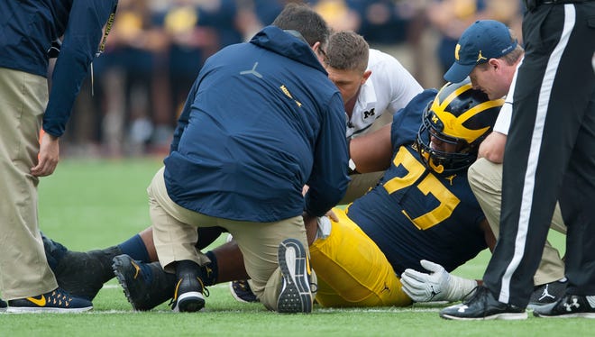The Michigan medical staff tends to injured Michigan offensive lineman Grant Newsome during the game against Wisconsin in October 2016.