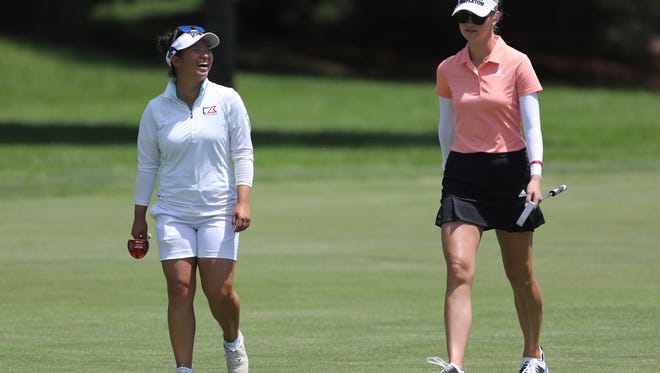 Megan Khang, left, and Jessica Korda walk up the ninth fairway during the first round of the LPGA Volvik Championship golf tournament.