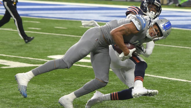 Lions Marvin Jones Jr. hangs onto a long first down reception in front of Bears' Eddie Jackson in the second quarter.