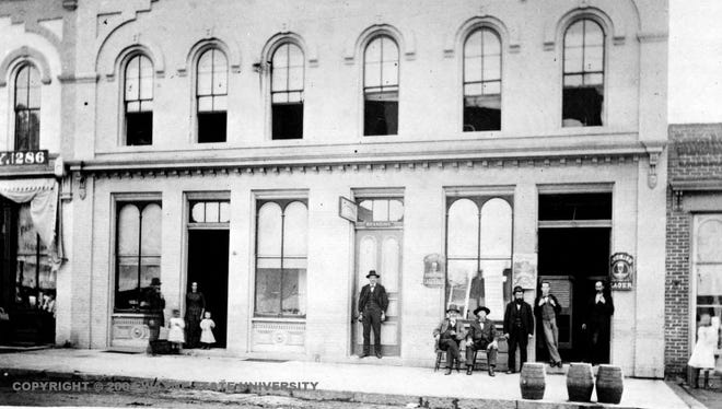 People lounge outside Peter Lutz's Boarding House and Saloon on Gratiot, date unknown. Prior to the 1870s, most single men lived in boarding houses, which provided room and food.