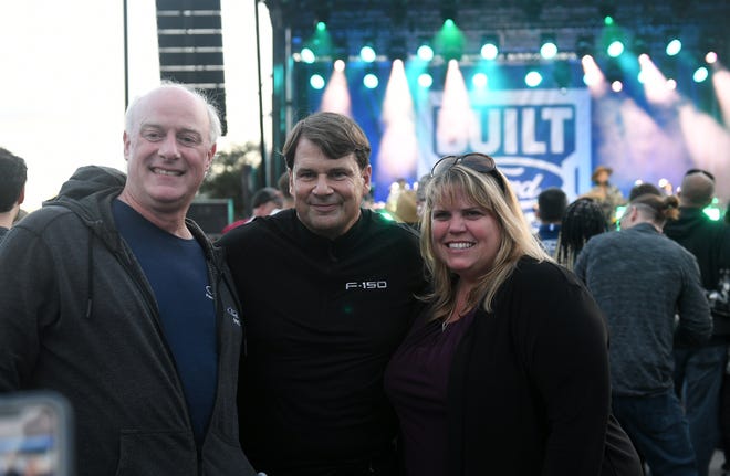 Paul Williamson, left, and Bloomfield Township supervisor Dani Walsh, right, pose for a photo with Ford CEO Jim Farley at the F-150 Fest with the 2024 Ford F-150 reveal at Hart Plaza in Detroit on Sept. 12, 2023.